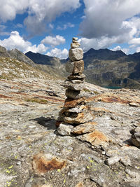 Stack of rocks on mountain against sky, rock cairn, find your way, passo della greina 