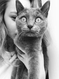 Portrait of young woman with cat