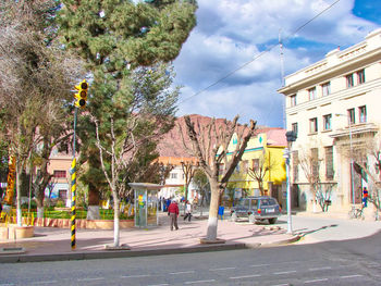 City street and buildings against sky