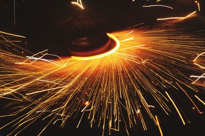 Low angle view of firework display at night