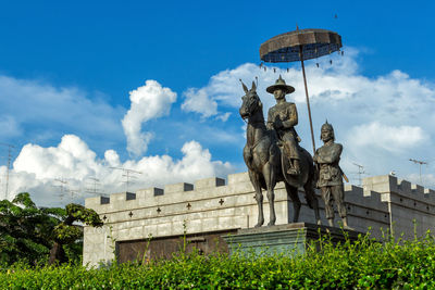 Low angle view of statue against cloudy sky