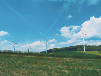 Windmill on field against sky