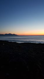 Scenic view of sea against clear sky during sunset