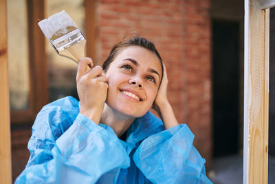 Portrait of young woman holding paper currency