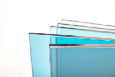 Close-up of blue colored pencils on white background