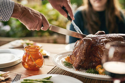 Midsection of woman preparing food on table