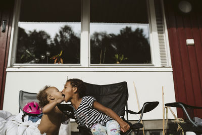 Kids together in front of house