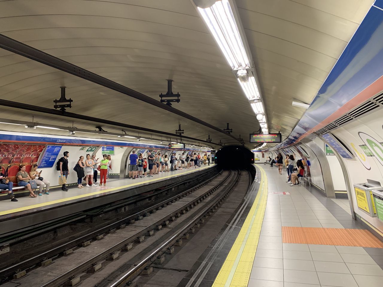 PEOPLE WAITING ON RAILROAD PLATFORM