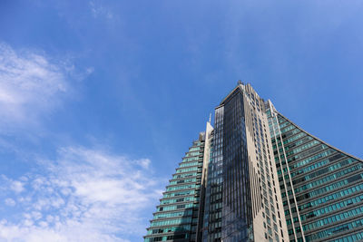 Low angle view of modern building against blue sky