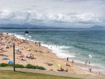 People on beach against sky