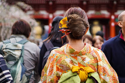 Rear view of people walking outdoors