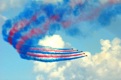 Low angle view of airshow against sky