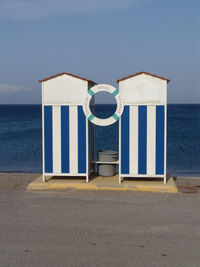 Lifeguard hut on beach against sky