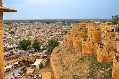 High angle view of townscape by sea against sky