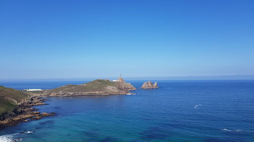 Scenic view of sea against clear blue sky