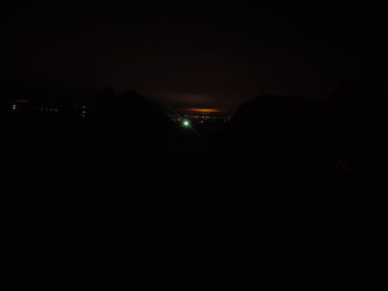 Illuminated city against sky at night
