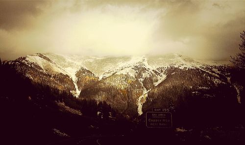 Scenic view of mountains against cloudy sky
