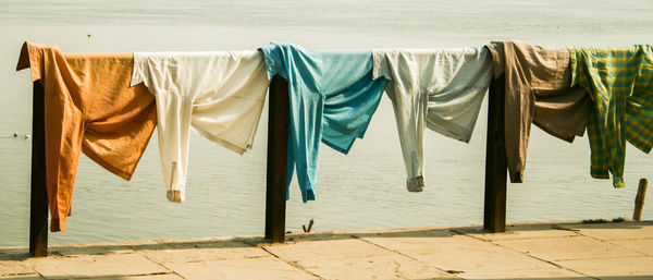 Clothes drying on pier against river