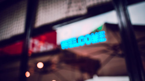 Close-up of text on illuminated sign board at night