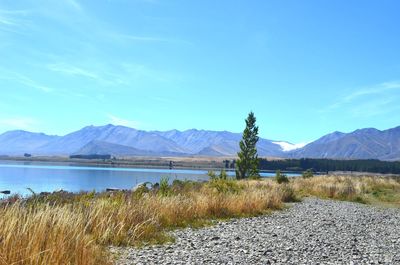 Scenic view of lake and mountains against sky