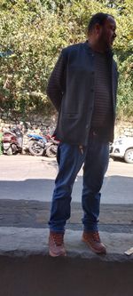 Rear view of man standing on street in city