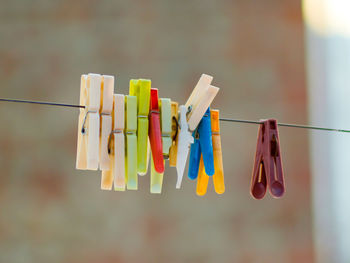 Close-up of clothespins hanging on clothesline