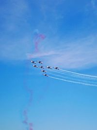 Low angle view of airshow against sky