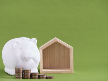 Close-up of coins on table against green background