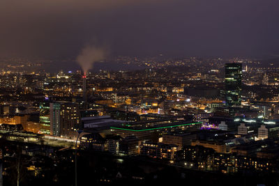 High angle view of illuminated city buildings at night