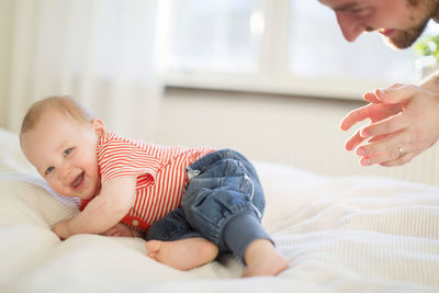 Father and son lying on bed