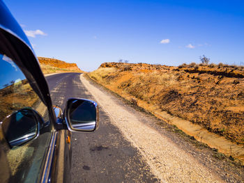 Car on road against blue sky