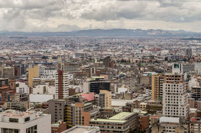 High angle view of city against cloudy sky