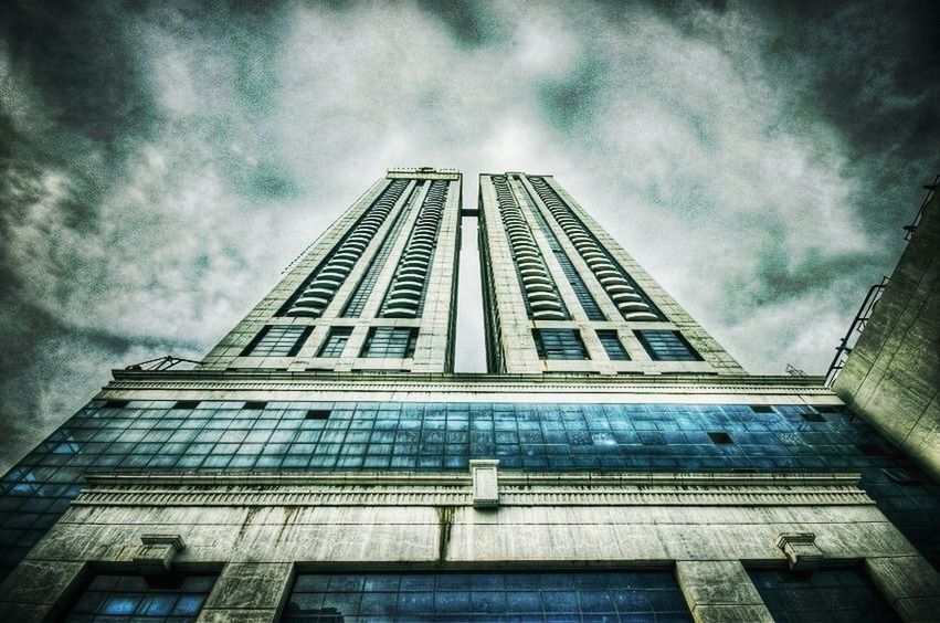 architecture, low angle view, built structure, building exterior, sky, cloud - sky, cloudy, cloud, building, overcast, window, modern, day, city, outdoors, no people, weather, glass - material, tall - high, tower