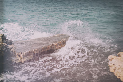 High angle view of waves flowing at sea