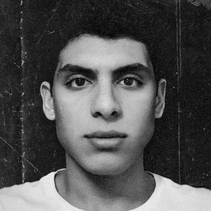 Close-up portrait of young man against wall