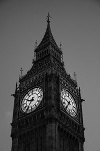 Low angle view of clock tower against clear sky