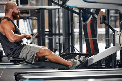 Low section of man repairing car