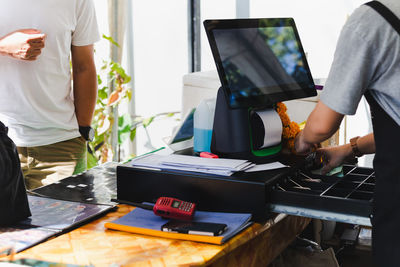 Midsection of man working in office