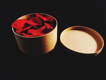 Close-up of cake against black background