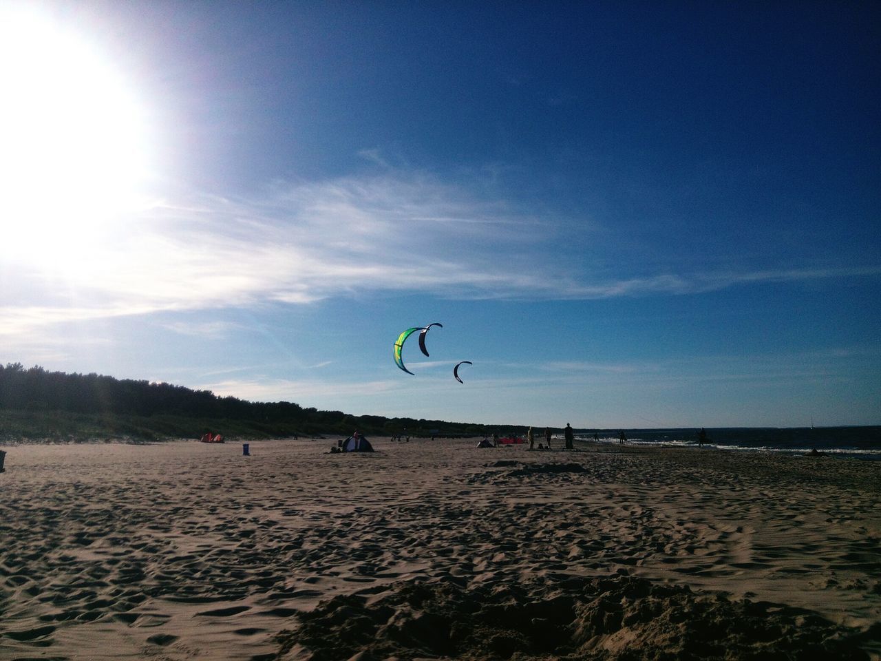 beach, sand, sea, shore, leisure activity, sky, lifestyles, scenics, vacations, tranquility, tranquil scene, horizon over water, beauty in nature, nature, sunlight, enjoyment, unrecognizable person, tourist, adventure, tourism, fun, blue, day, outdoors, idyllic, cloud - sky, coastline