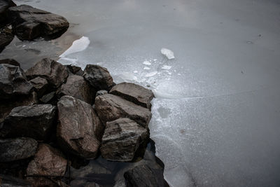 High angle view of rocks on sea shore during winter