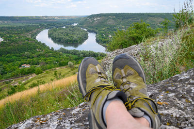 Low section of person wearing shoes on land