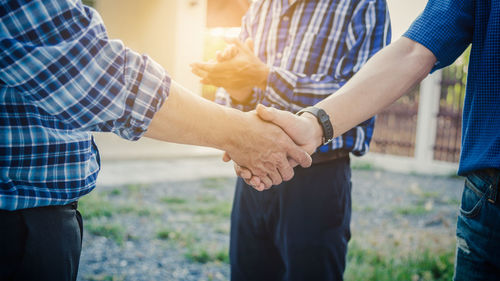 Midsection of man holding hands