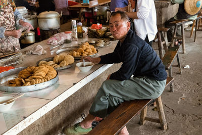 Side view of man preparing food at store