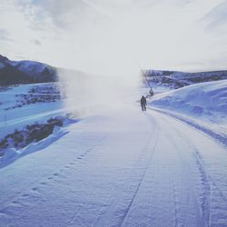 Person skiing on snowcapped mountain against sky