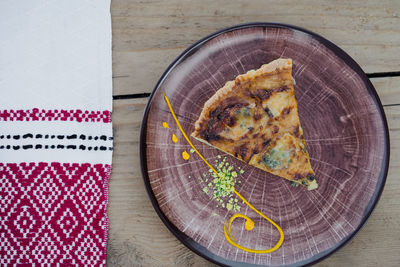 High angle view of pie in plate on table