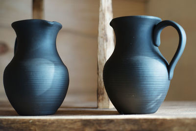 Close-up of pots on shelf at workshop