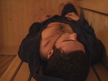 Portrait of young man sleeping on floor at home