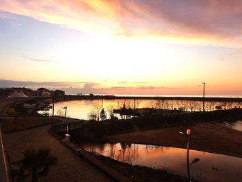 Scenic view of river against sky during sunset