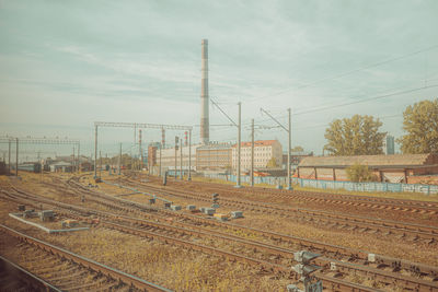 Railroad tracks on field against sky